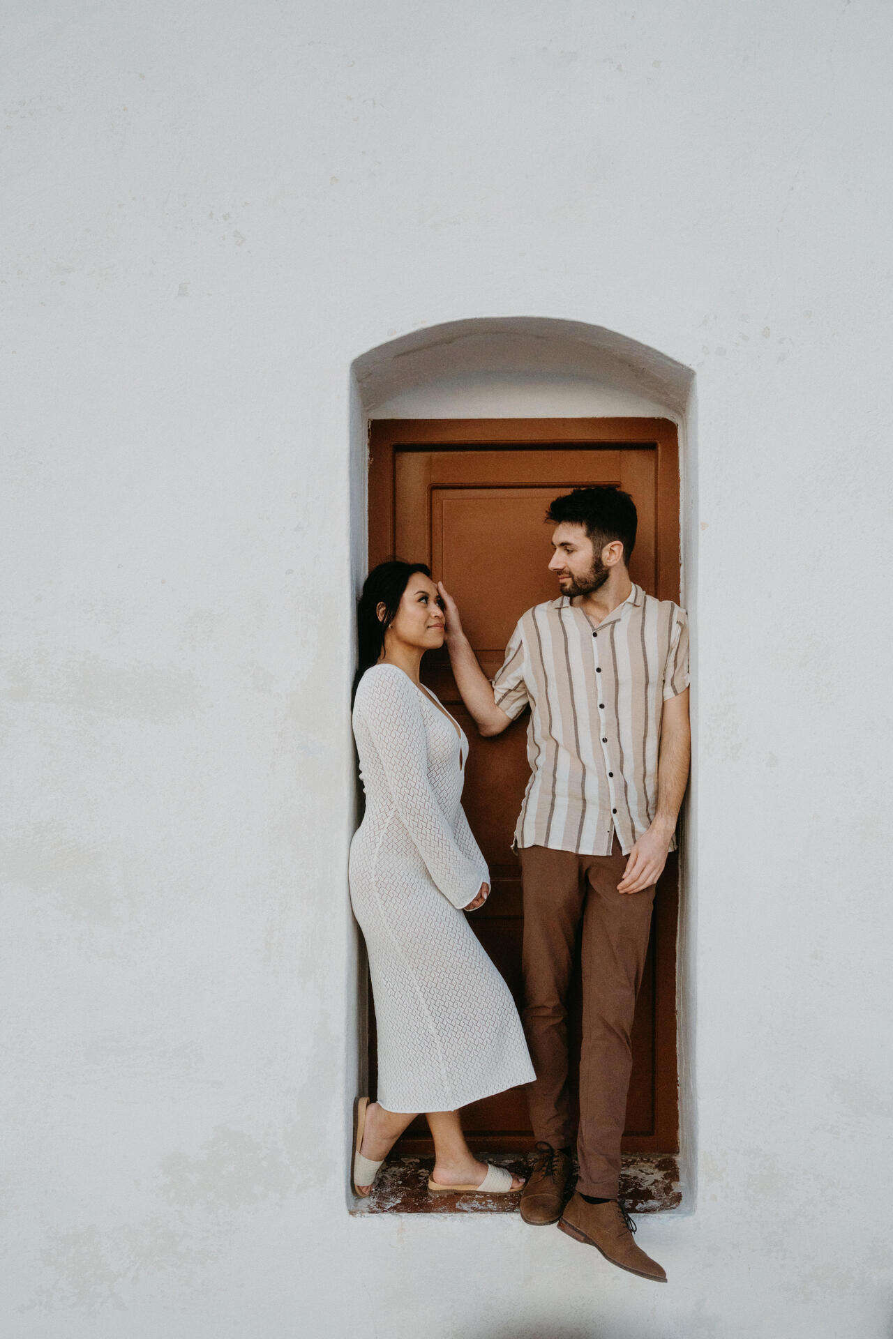 Couple exchanging vows at a clifftop ceremony on Milos